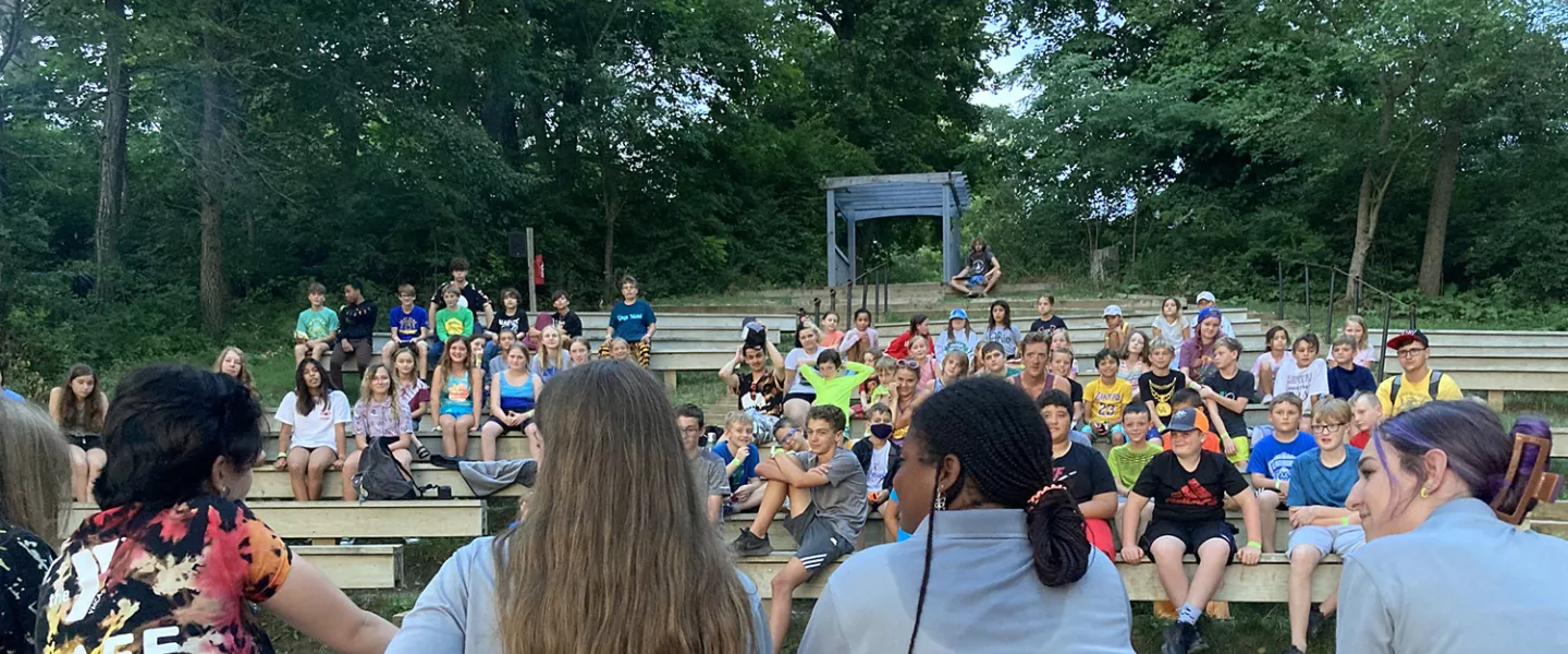 Camp staff leading campers at waterfront amphitheater
