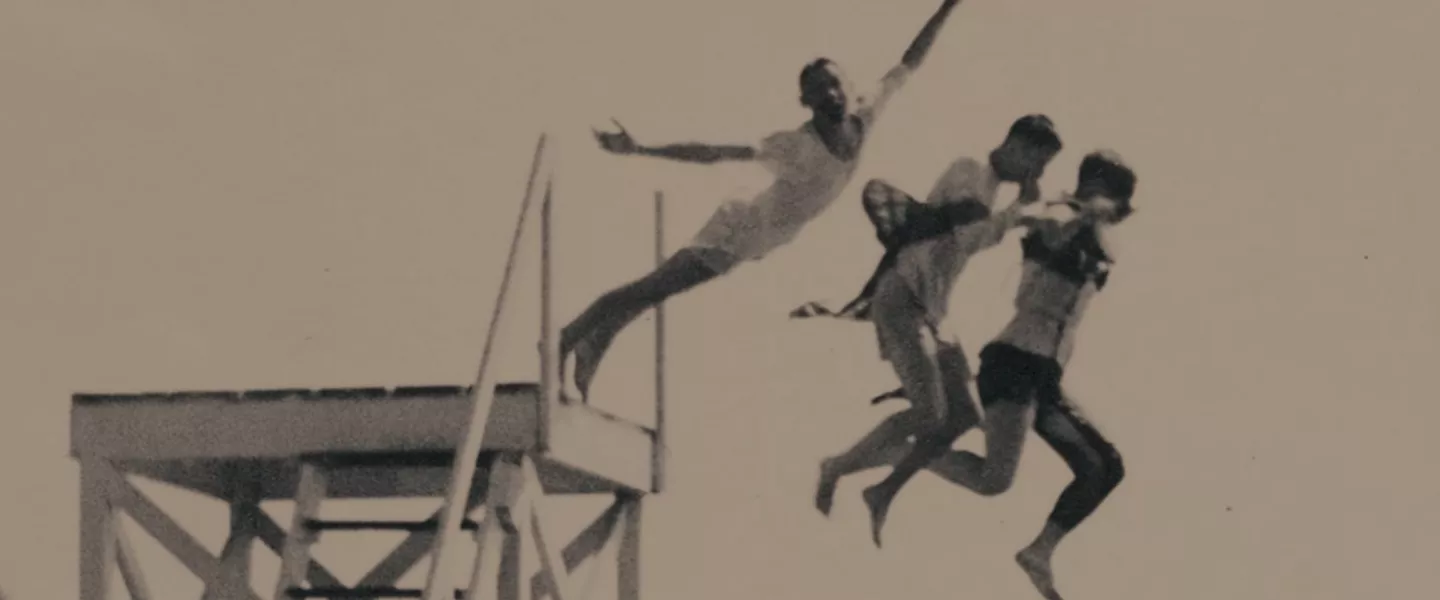 historical image of campers jumping off high dive