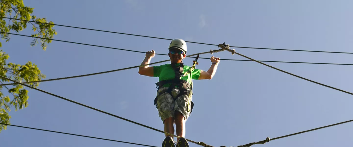 Camper on high ropes course