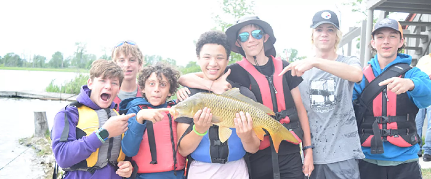 Fishing campers holding fish