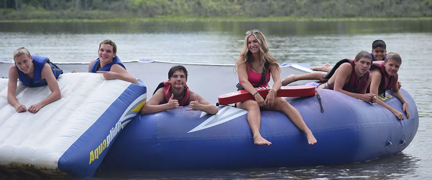 Campers hanging out on a water trampoline