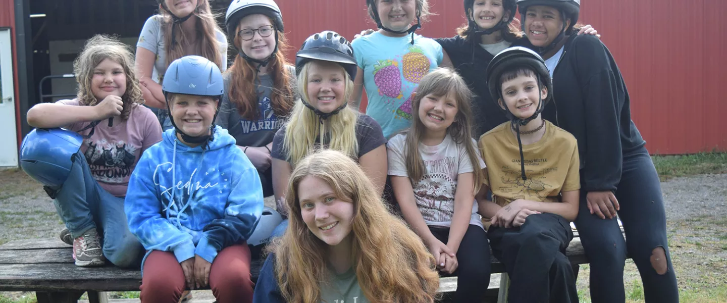 Campers in helmets at the ranch