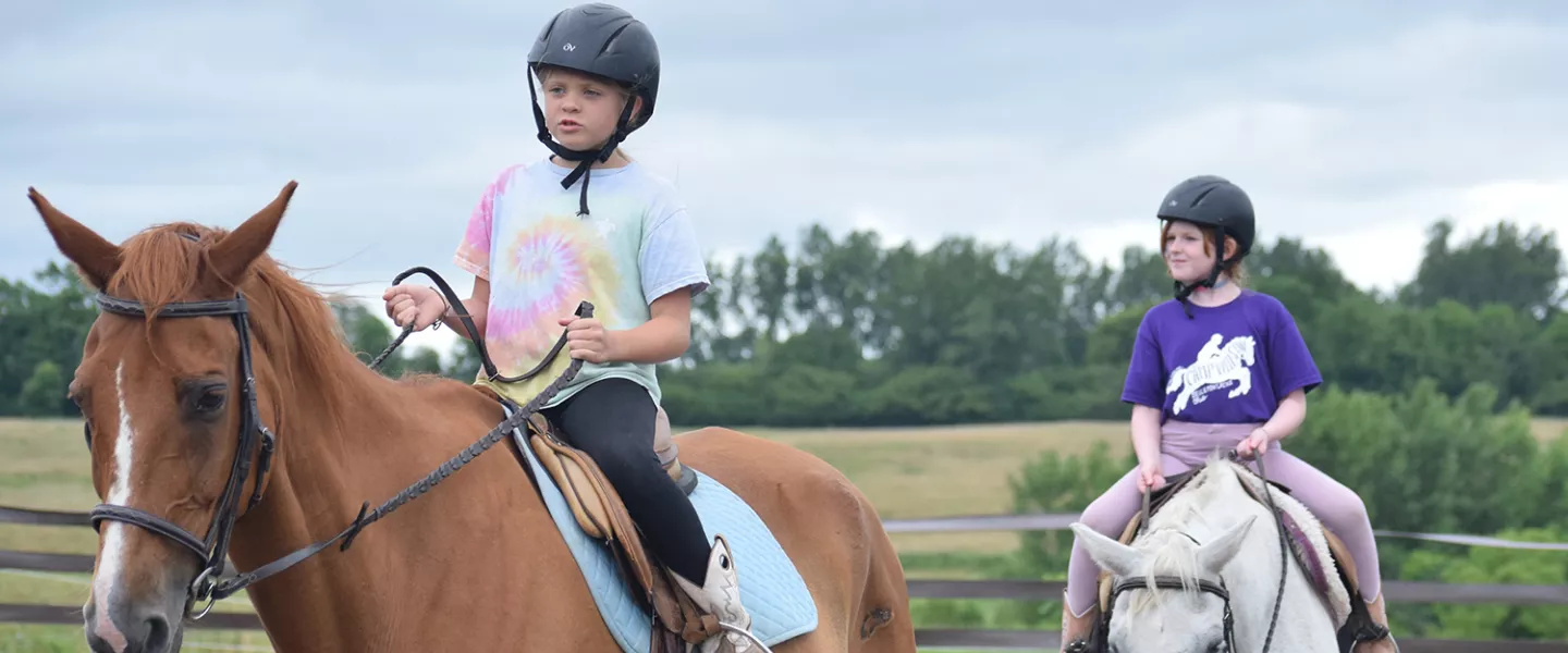 Campers riding horses