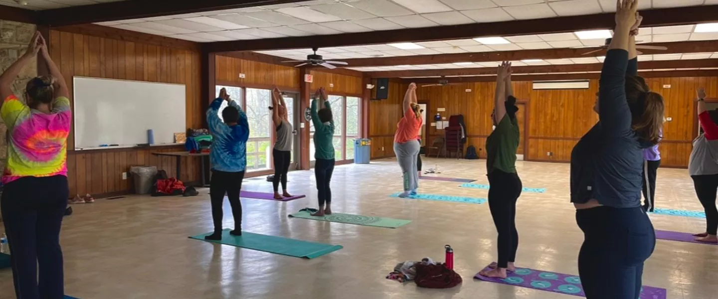 women's weekend campers doing indoor yoga