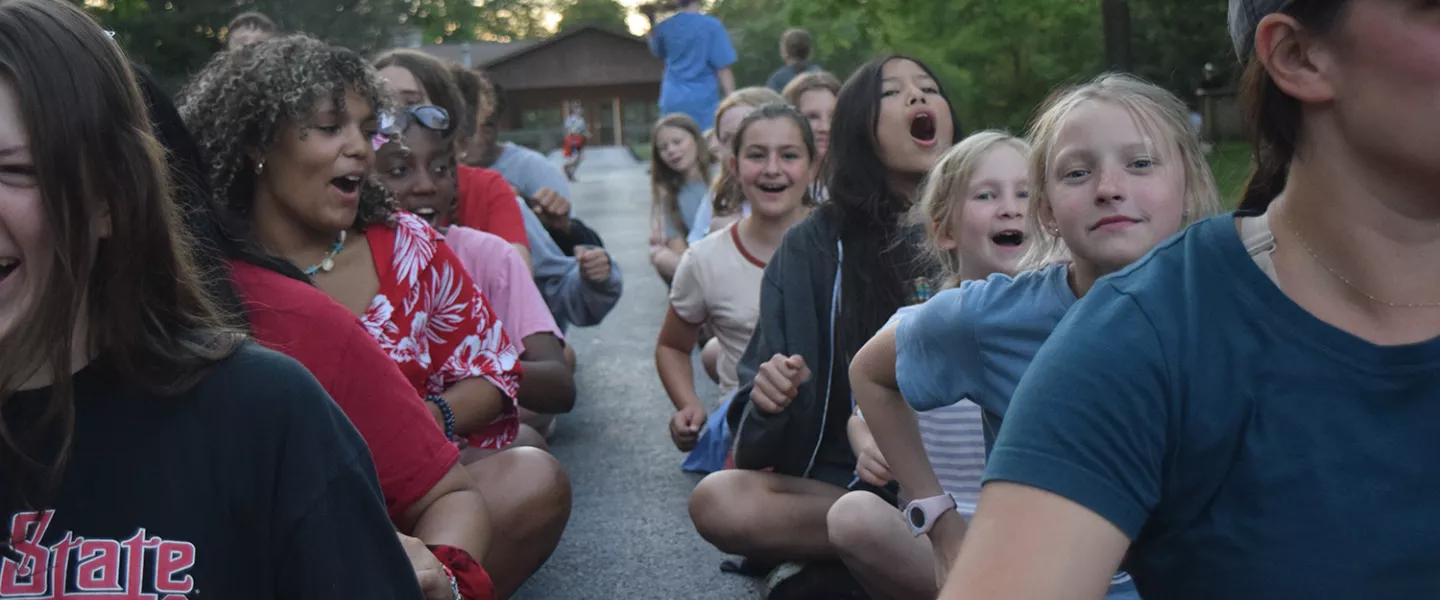 group of kids sitting outside