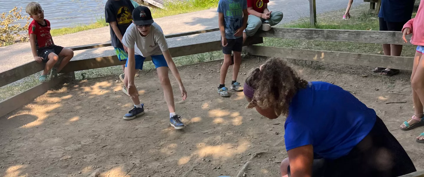 campers playing a game near the lake