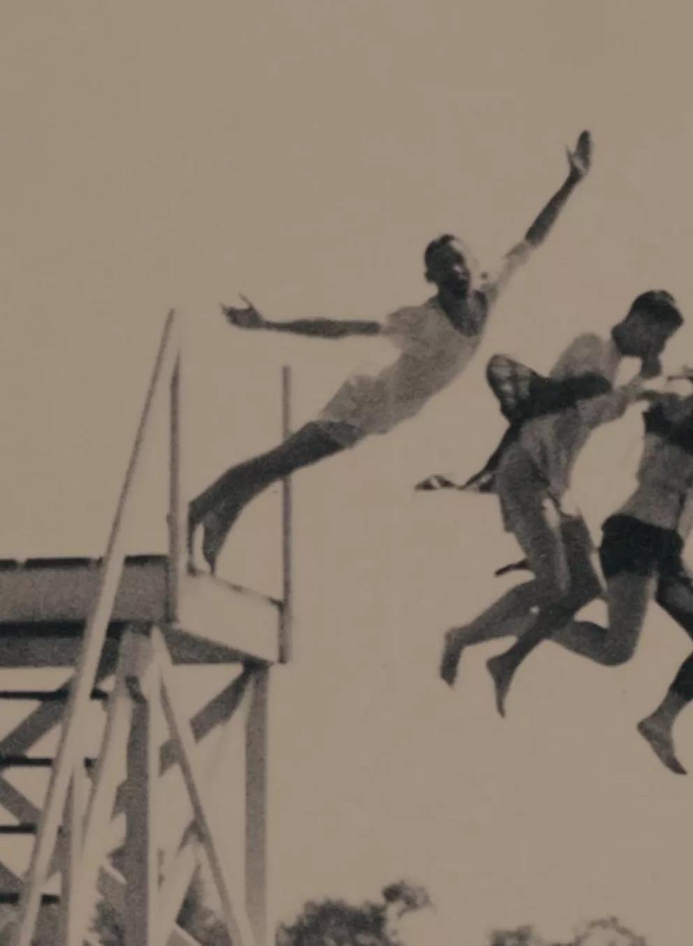 historical image of campers jumping off high dive