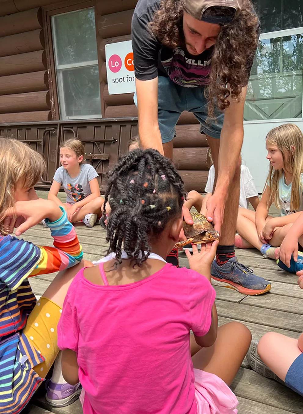 Staff showing campers a turtle