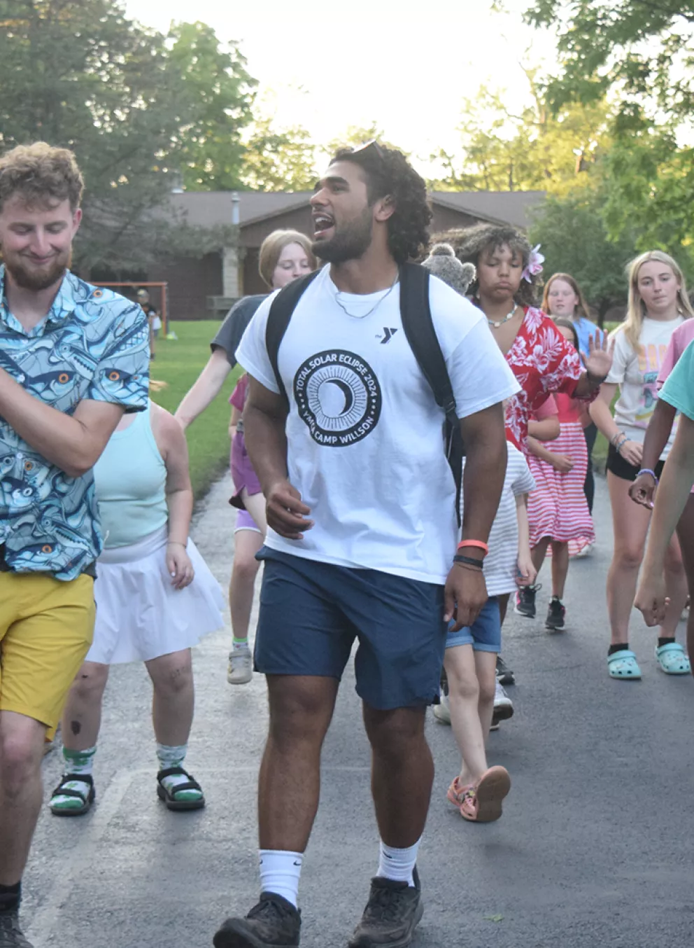 Staff and campers dancing outside