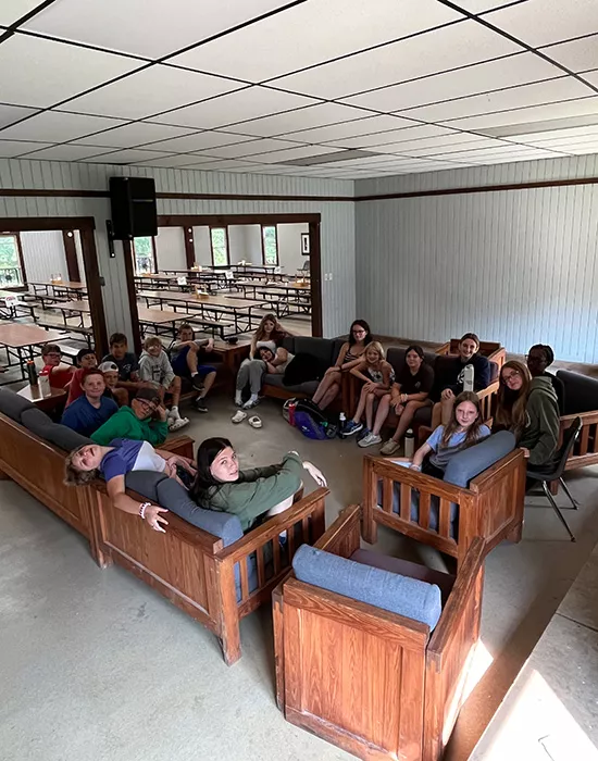 Campers sitting on chairs in dining hall