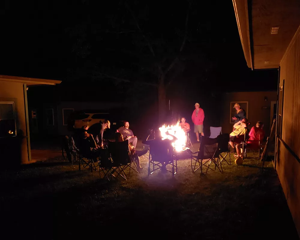 men's campers around a campfire