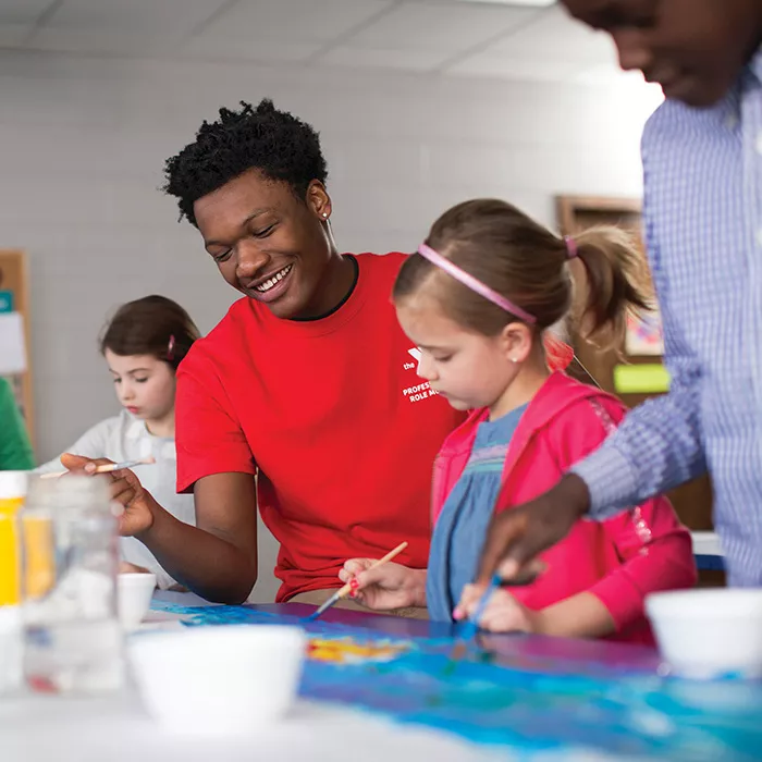 YMCA staff painting with kids