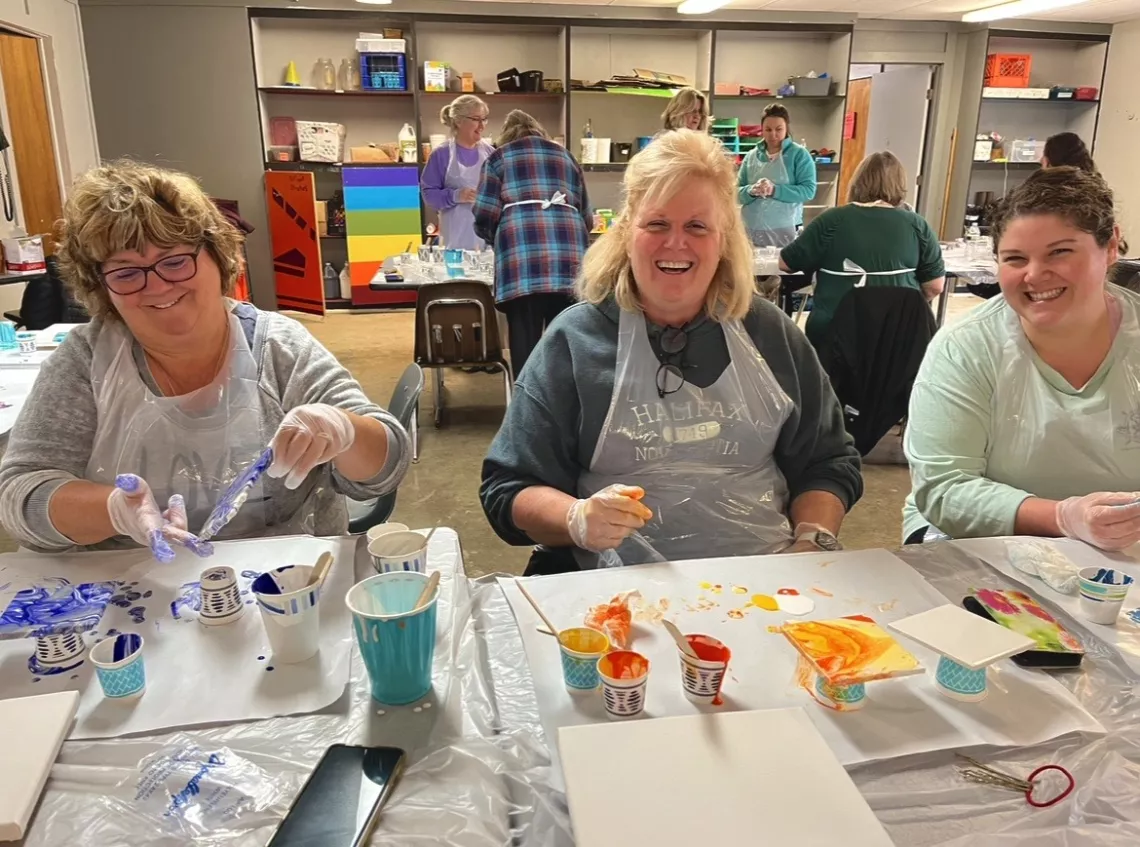 Women doing a craft at camp